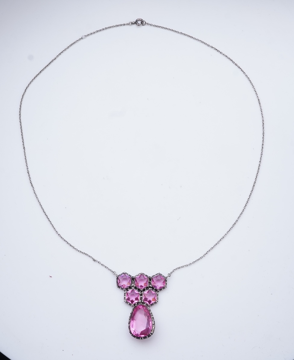 A cut steel brooch, 19th century, and a pink paste pendant